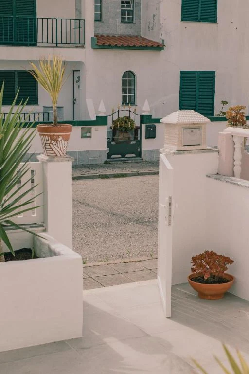 Quiet street and green shutters near Supertubos House in Atouguia da Baleia
